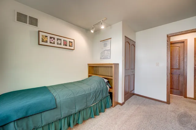 a view of a hallway with closet and cabinet
