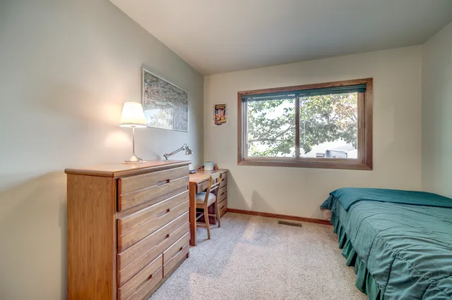 a bathroom with a toilet a sink a mirror a bathtub and vanity