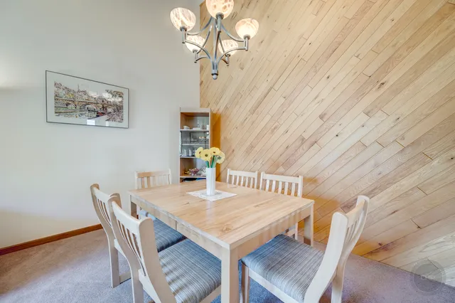a view of a dining room with furniture and a chandelier