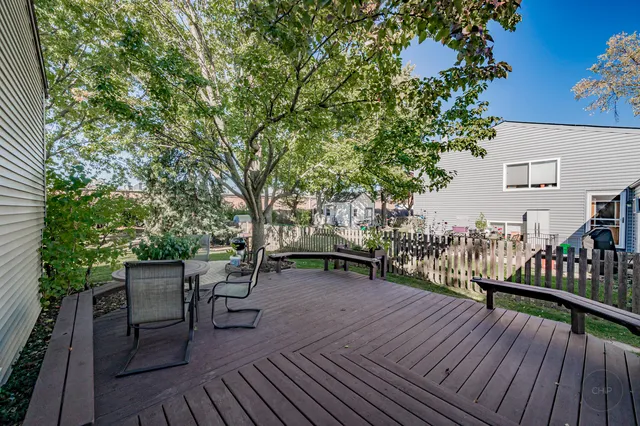 a view of a house with backyard and a tree