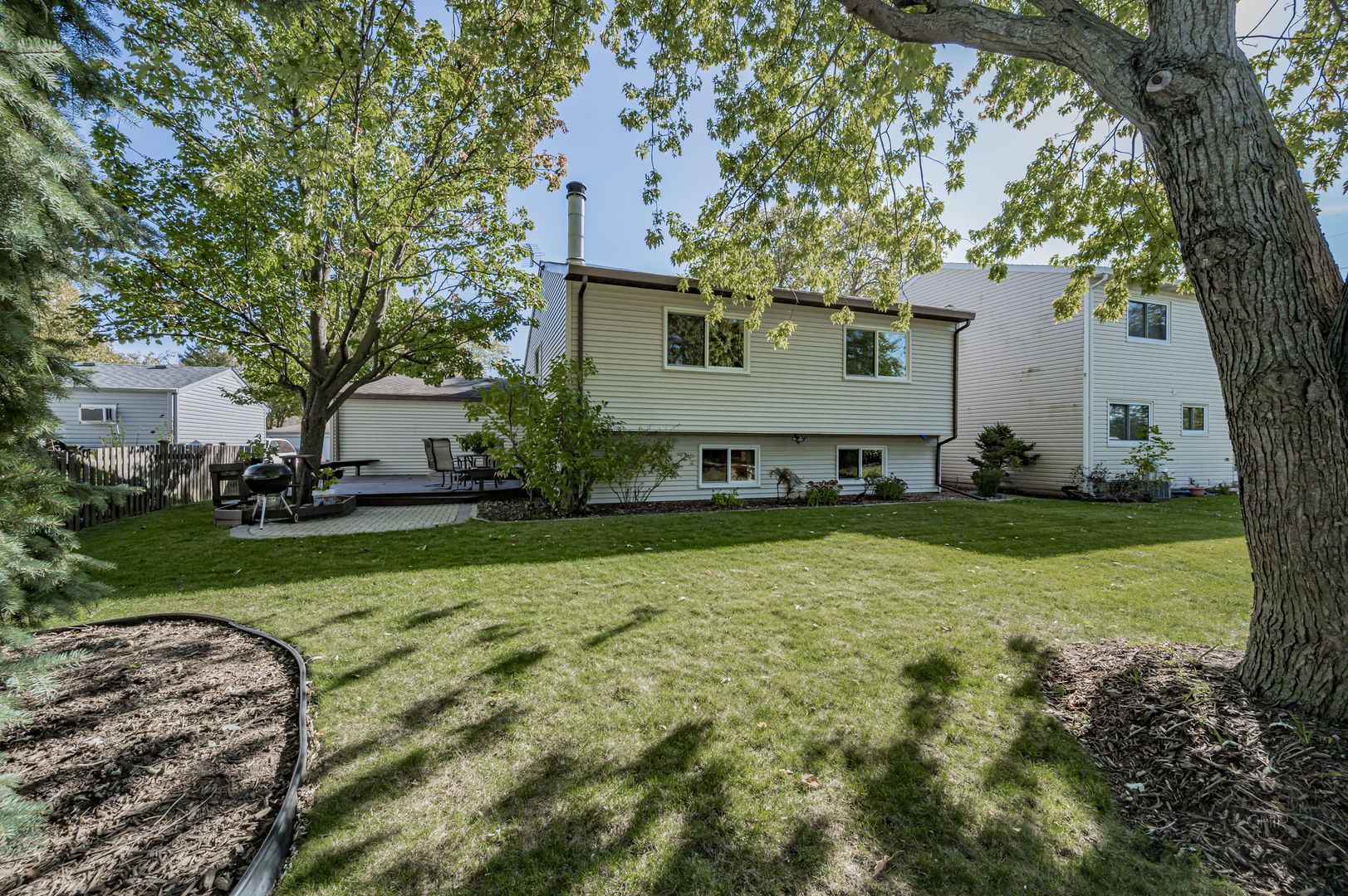 1259 Natchez Trace Circle Naperville, IL 60565 - Photo 47 of 56 a view of a house with backyard and a tree