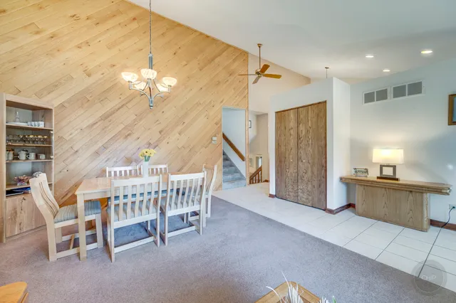 a dining room with furniture and chandelier