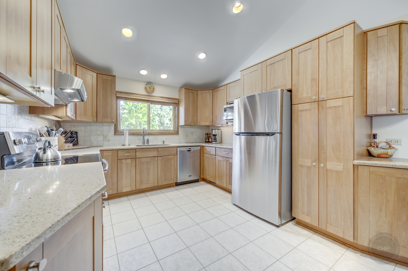 1259 Natchez Trace Circle Naperville, IL 60565 - Photo 9 of 56 a kitchen with a refrigerator a sink and cabinets