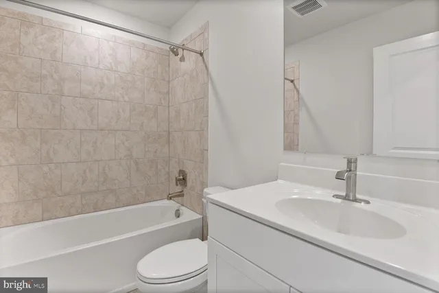 a bathroom with a granite countertop sink mirror and shower