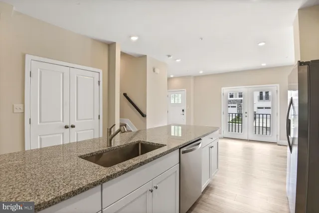 a kitchen with granite countertop a sink and cabinets