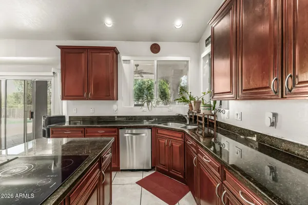 a kitchen with stainless steel appliances granite countertop counter space a sink and cabinets