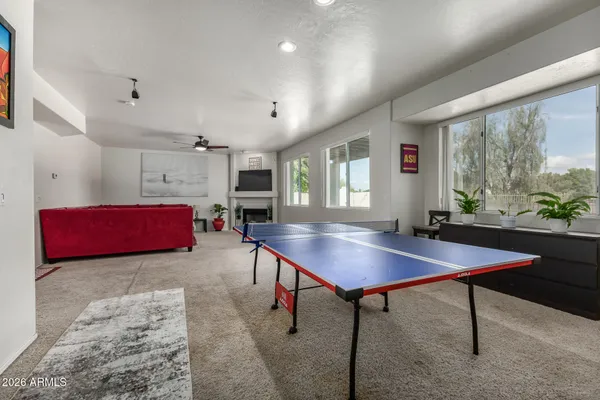 a room with furniture pool table and windows