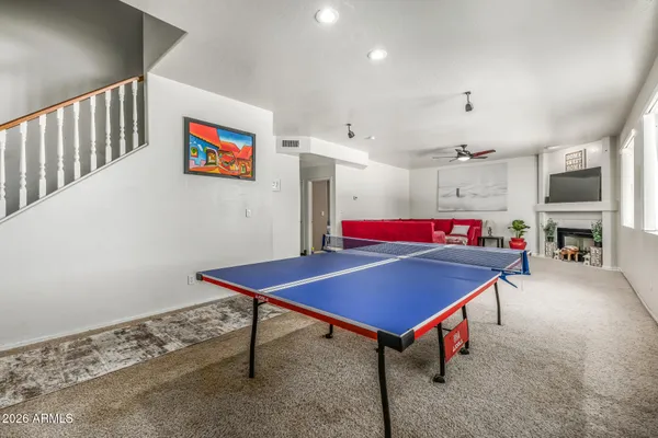 a living room with furniture pool table and rug