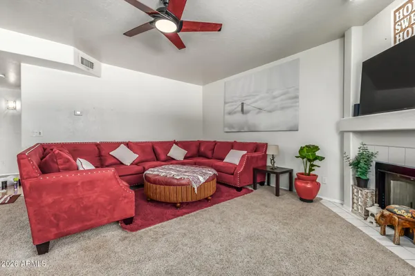 a living room with furniture and a fireplace