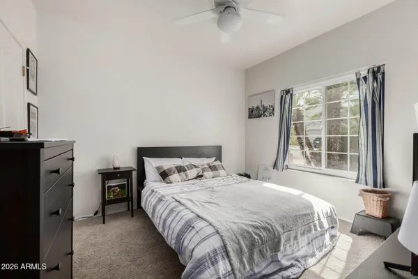 a bedroom with a bed and a tv