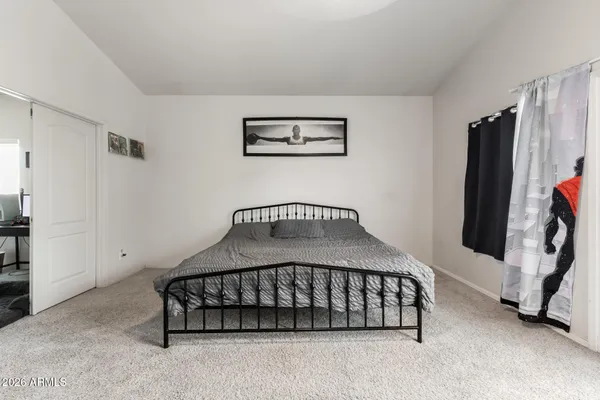 a bedroom with a bed and a window