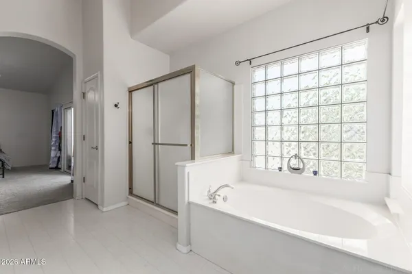 a bathroom with a bathtub and a shower