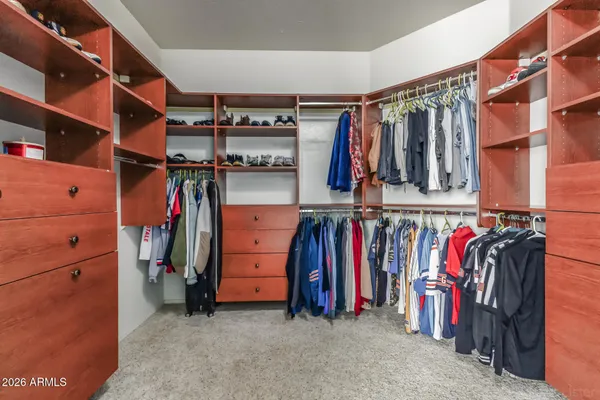 a view of walk in closet with clothes
