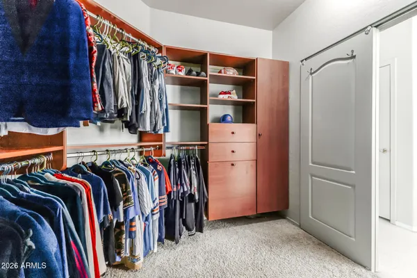 a view of walk in closet with clothes