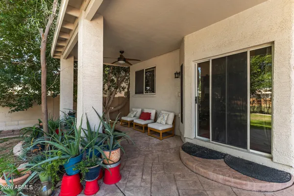 a view of a white house with a big yard and large trees