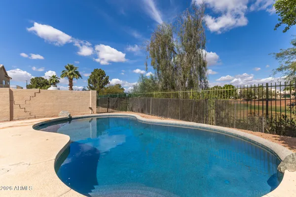 a swimming pool with outdoor seating and yard
