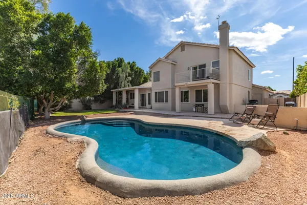 a view of a swimming pool with an outdoor space and seating area