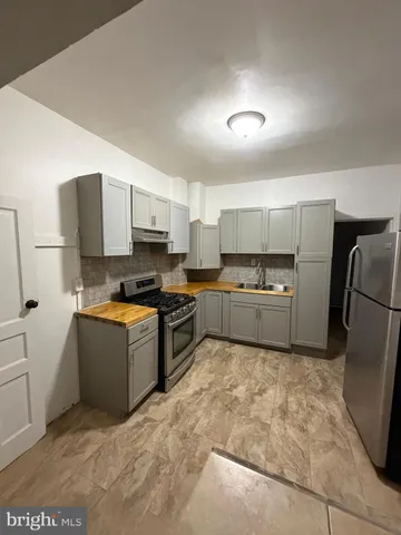 a kitchen with a refrigerator a stove top oven a sink and dishwasher