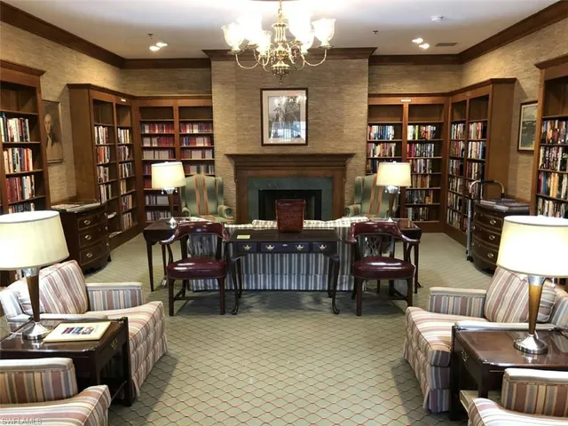 a living room with furniture a bookshelf and a fireplace