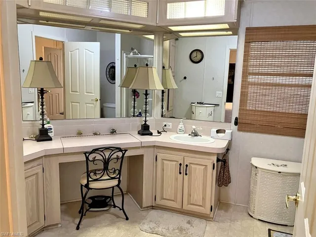 a bathroom with a sink a mirror a toilet and a shower