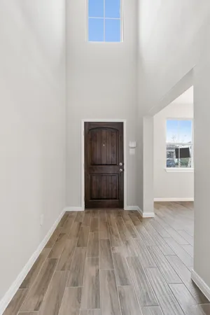 a large kitchen with stainless steel appliances kitchen island a large counter top and a wooden floors