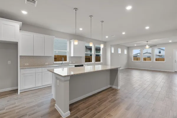 a kitchen with granite countertop a stove and a microwave