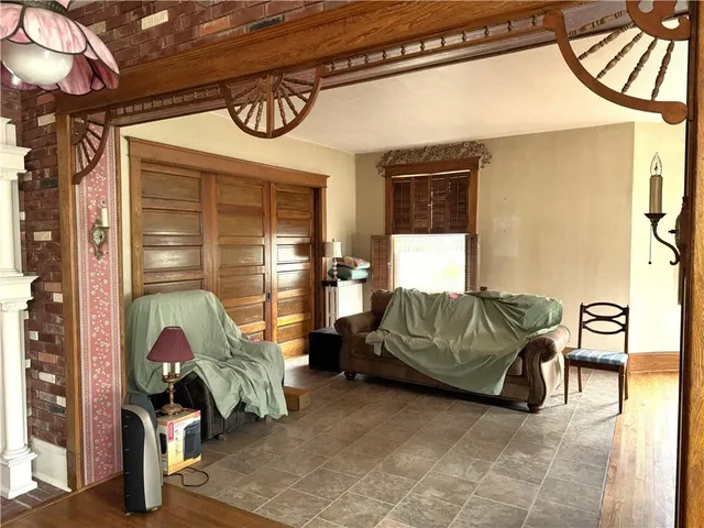 a living room with furniture a flat screen tv and a large window