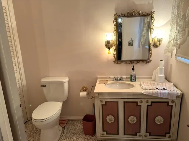 a bathroom with a toilet sink and mirror