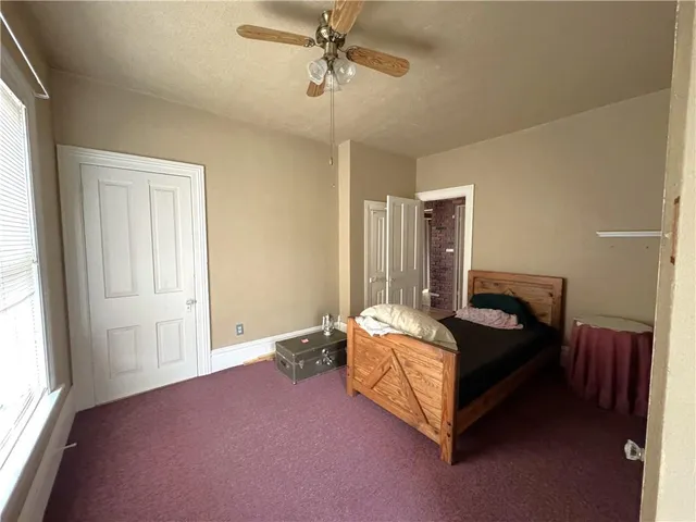 a bed room with a bed and a window