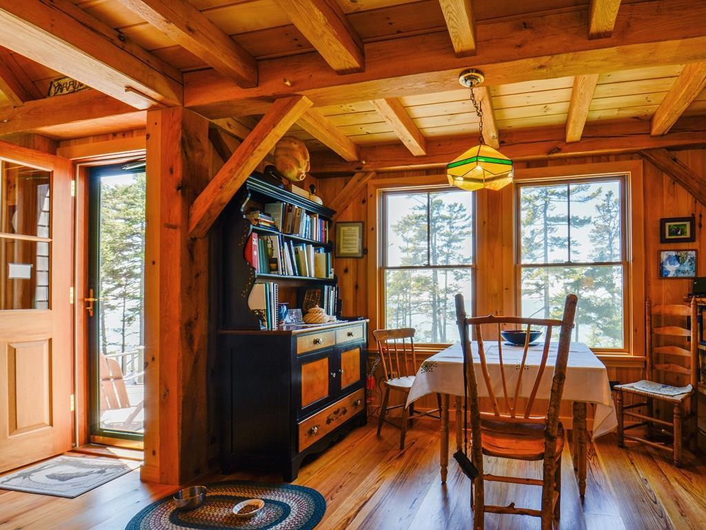 555 Jericho Bay Road Swans Island, ME 04685 - Photo 13 of 35 Dining table with exterior door to deck.