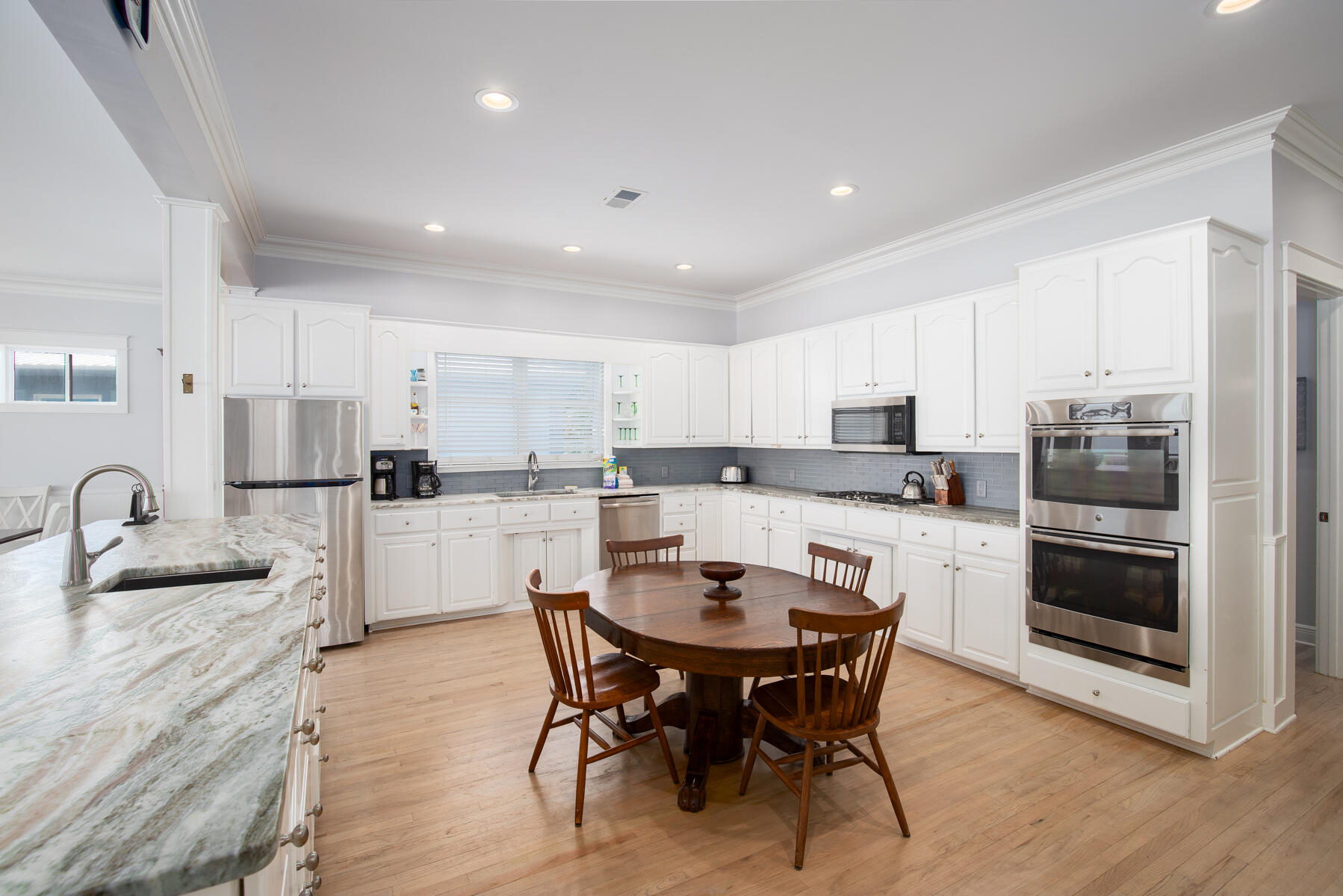 2 Hotz Avenue Santa Rosa Beach, FL 32459 - Photo 11 of 54 a kitchen with a dining table chairs sink and cabinets
