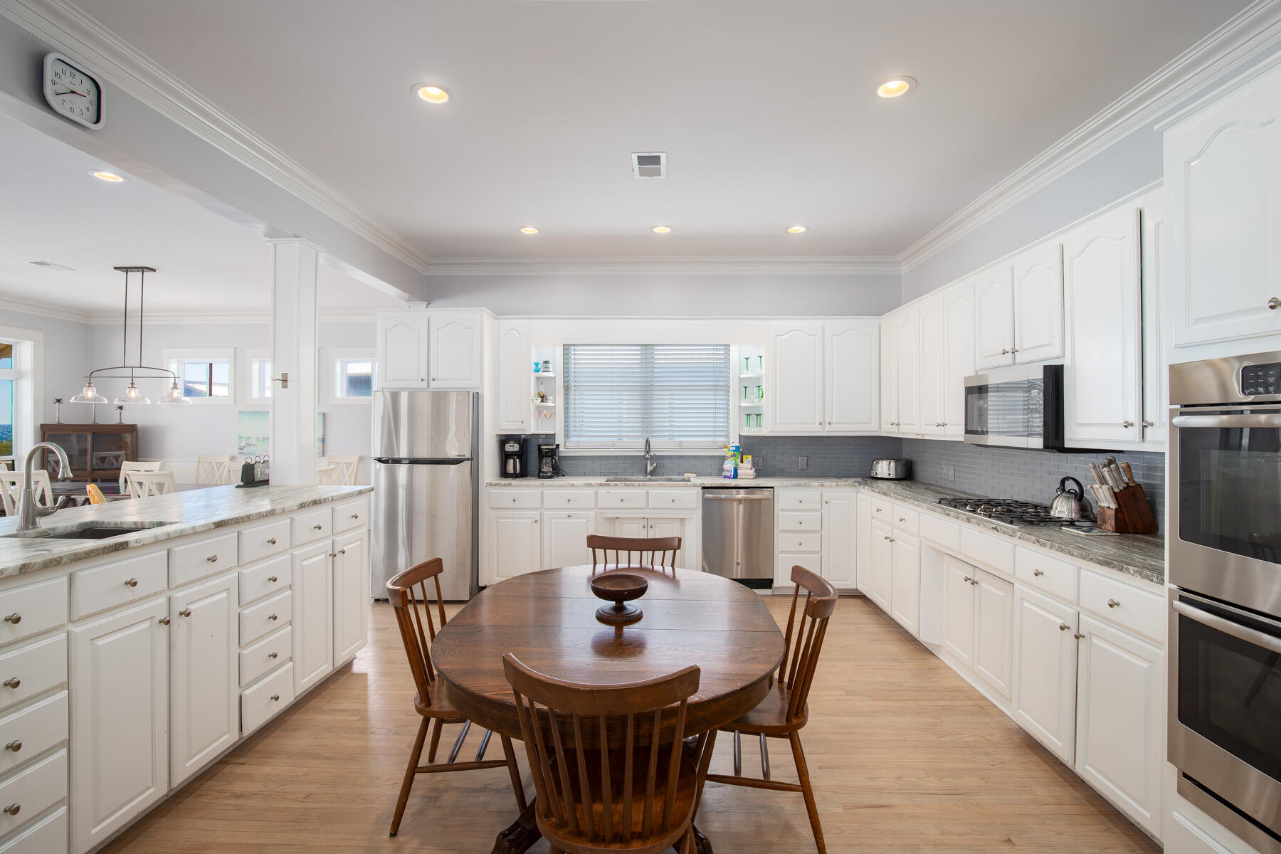 2 Hotz Avenue Santa Rosa Beach, FL 32459 - Photo 12 of 54 a large kitchen with kitchen island granite countertop lots of white cabinets appliances and furniture