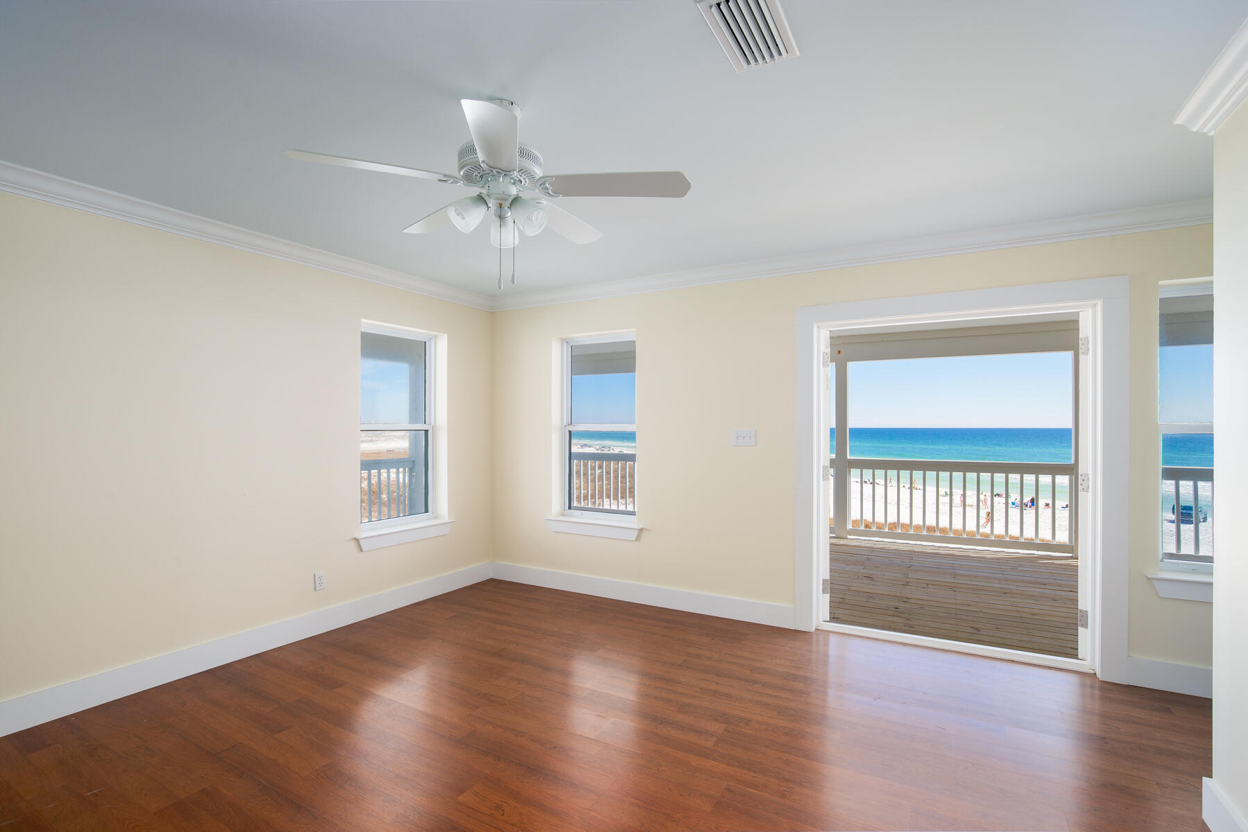 2 Hotz Avenue Santa Rosa Beach, FL 32459 - Photo 19 of 54 an empty room with wooden floor fan and windows