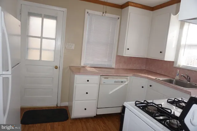 a kitchen with stainless steel appliances white cabinets and stove