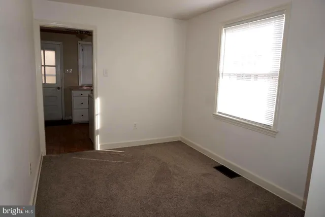 a view of empty room with a fireplace