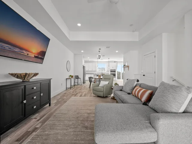 a living room with furniture and kitchen view