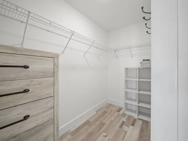 a view of walk in closet with empty racks