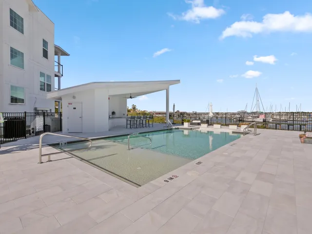 a view of a swimming pool and outdoor seating