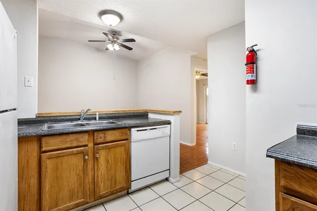 a utility room with a sink and cabinets