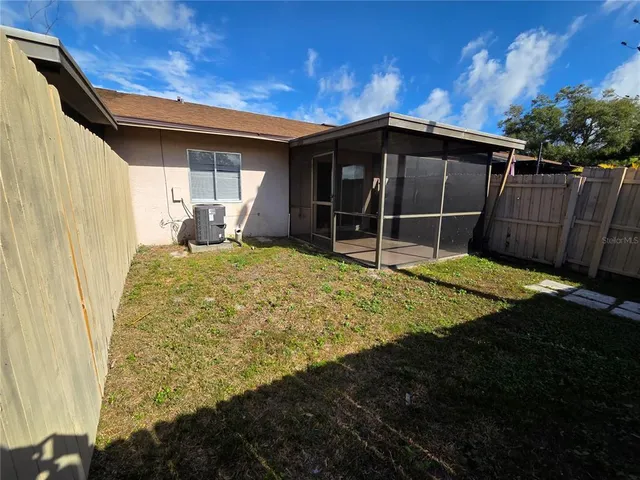 a view of a house with backyard and sitting area