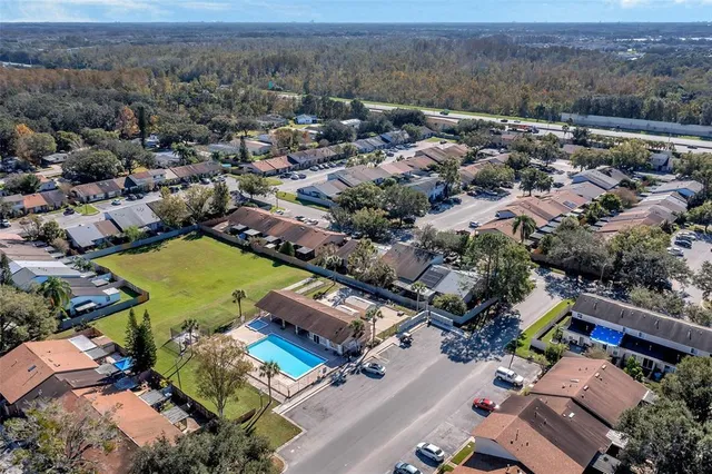 an aerial view of residential houses with outdoor space