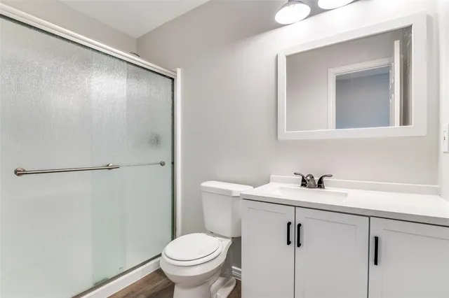 a bathroom with a sink toilet and vanity