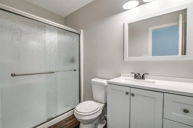 an empty room with closet and chandelier fan