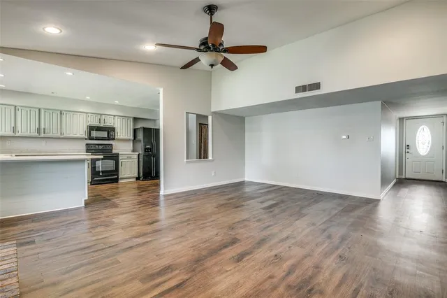 a view of a kitchen with a sink and a refrigerator