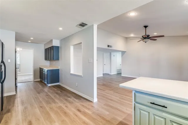 a view of a kitchen with a sink and a refrigerator