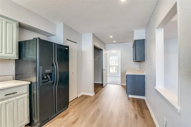 a kitchen with stainless steel appliances a refrigerator and a stove