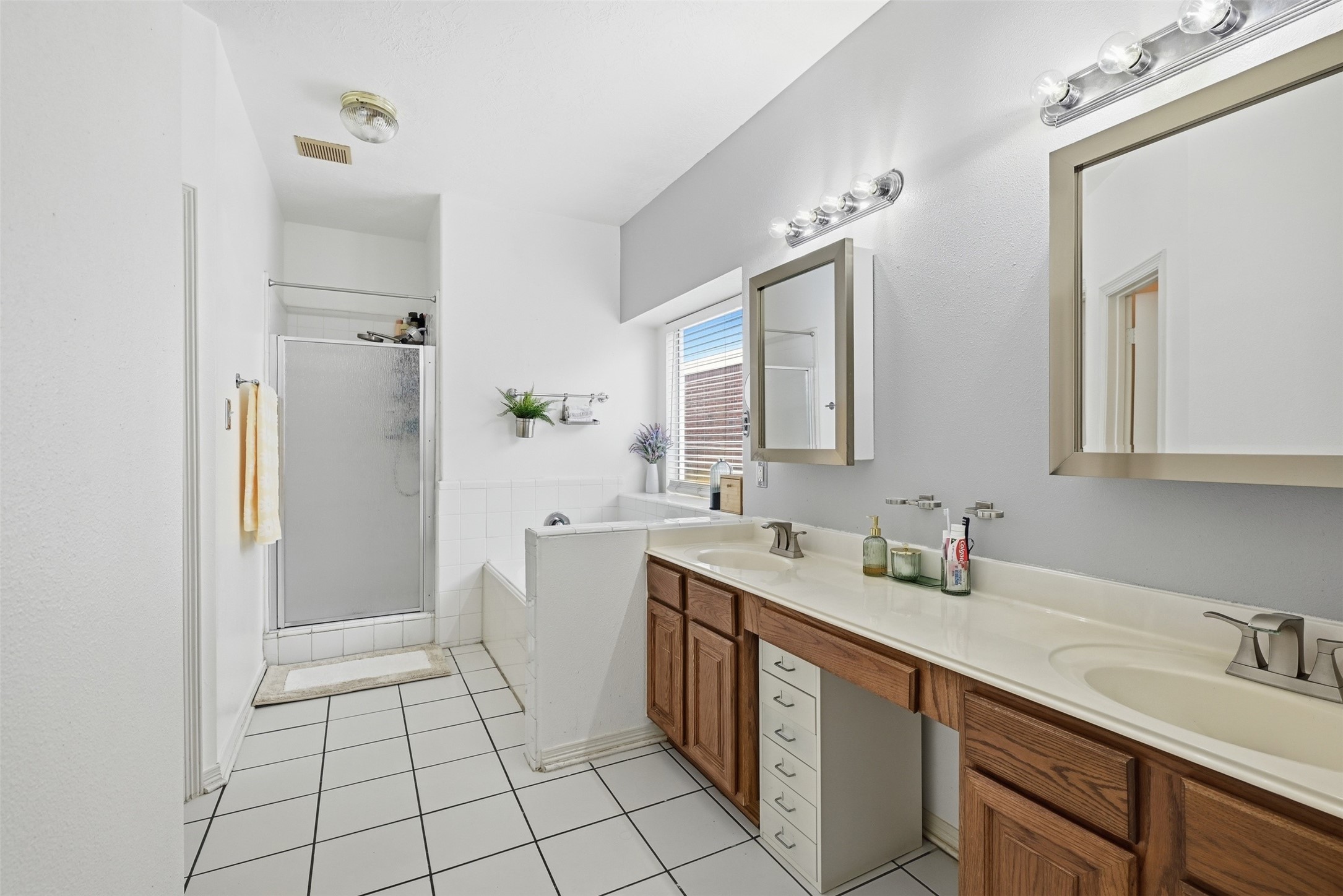 23819 Spring Dane Drive Spring, TX 77373 - Photo 18 of 42 The primary bathroom offers a double vanity for him and her along with a separate shower and soaking tub.