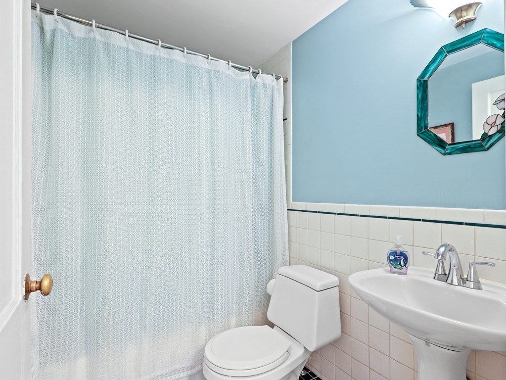 26 Elda Road Framingham, MA 01701 - Photo 11 of 27 a bathroom with a sink a toilet and a mirror