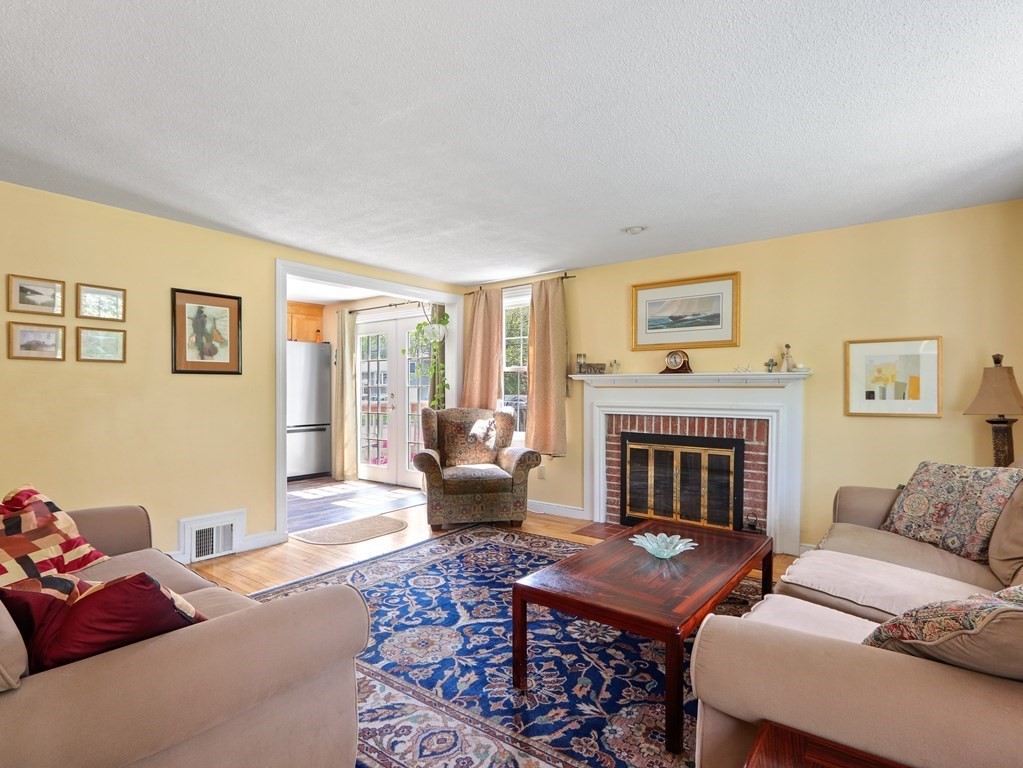 26 Elda Road Framingham, MA 01701 - Photo 2 of 27 a living room with furniture a rug and a fireplace