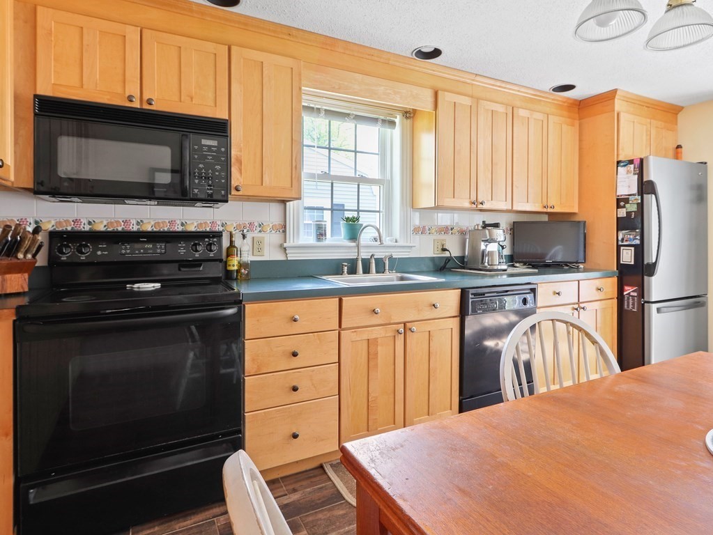 26 Elda Road Framingham, MA 01701 - Photo 6 of 27 a kitchen with a stove a sink and a microwave